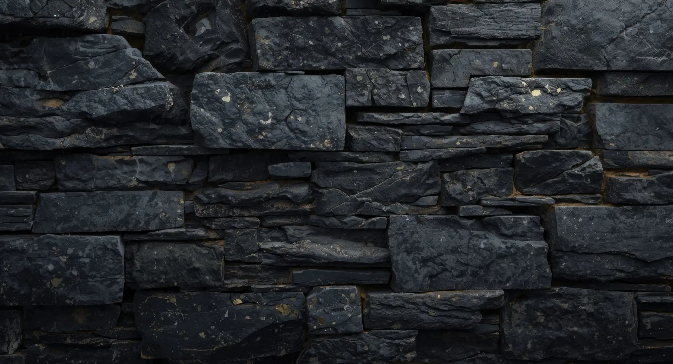 Dark stacked natural stone masonry wall by Lastovica Masonry in Omaha, NE